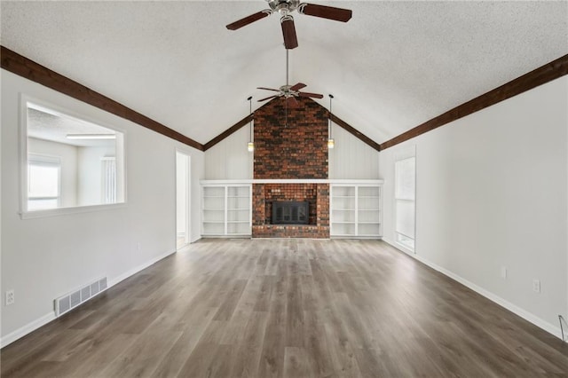 unfurnished living room featuring a textured ceiling, vaulted ceiling, ceiling fan, wood-type flooring, and a fireplace