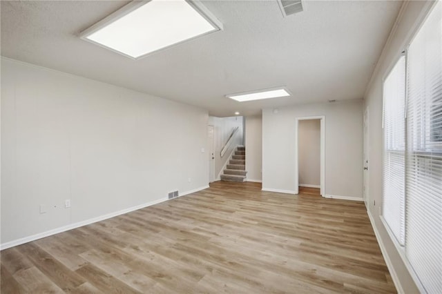 basement with light hardwood / wood-style floors