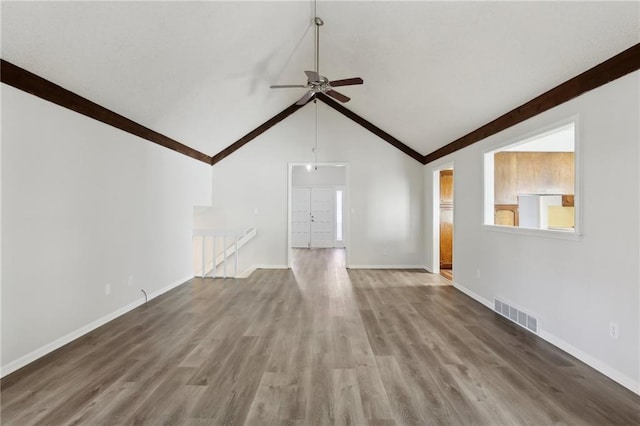 unfurnished living room with hardwood / wood-style flooring, ceiling fan, and high vaulted ceiling