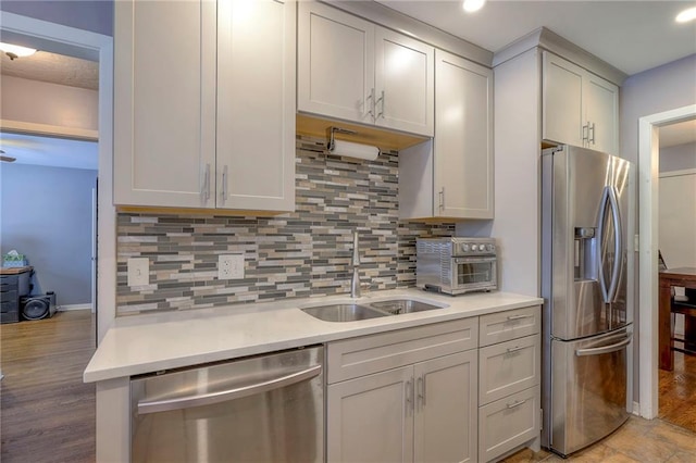 kitchen with stainless steel appliances, sink, and decorative backsplash