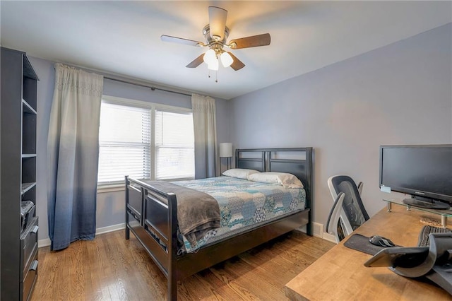 bedroom with ceiling fan and light hardwood / wood-style flooring