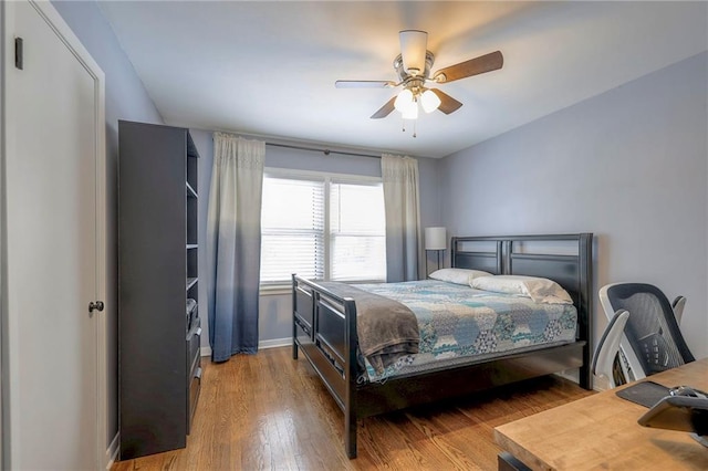 bedroom with wood-type flooring and ceiling fan