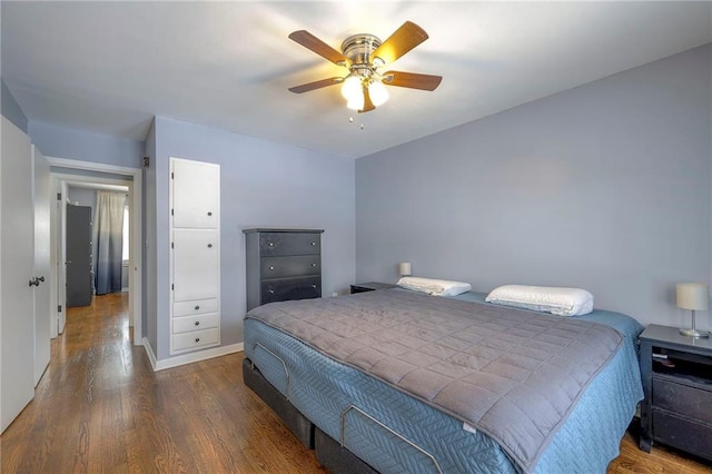 bedroom with dark wood-type flooring and ceiling fan