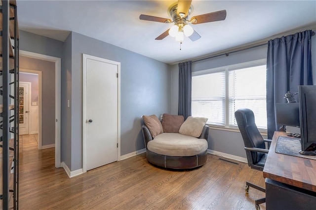 home office with hardwood / wood-style flooring and ceiling fan