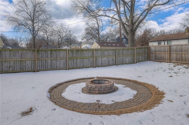 yard layered in snow with a fire pit