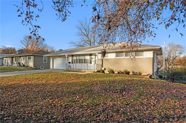 ranch-style house with a porch and a garage