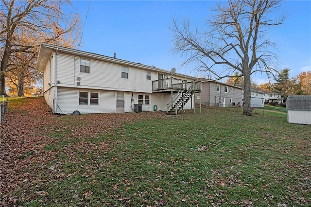 rear view of house featuring a lawn, central air condition unit, a storage unit, and a deck