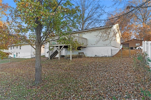 back of house featuring a wooden deck