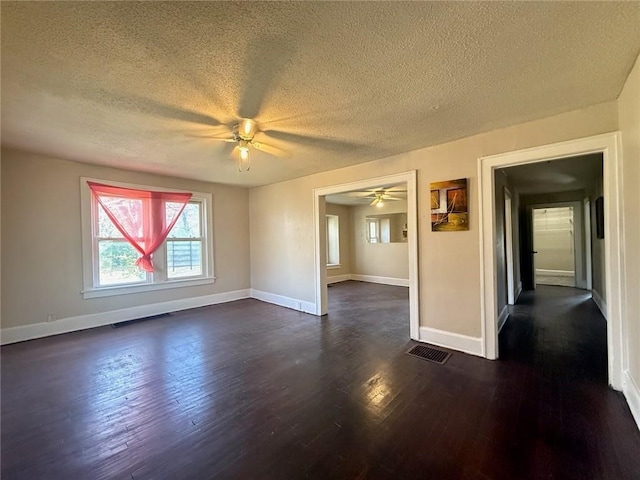 unfurnished room with a textured ceiling, dark hardwood / wood-style flooring, and ceiling fan