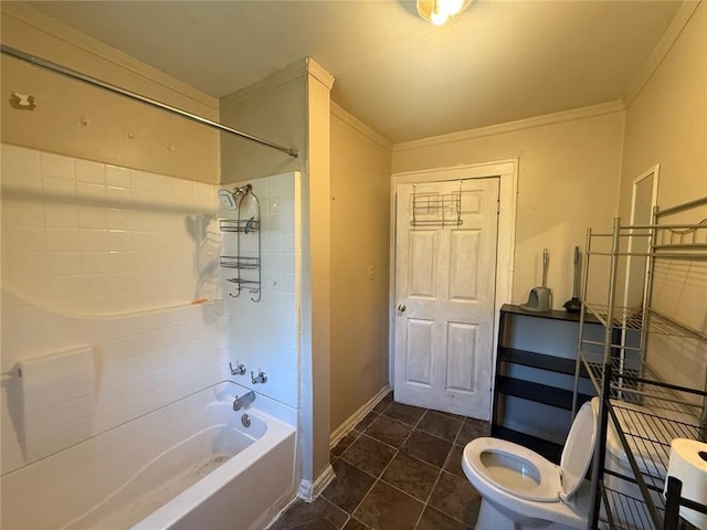 bathroom featuring tile patterned flooring, toilet, crown molding, and tiled shower / bath