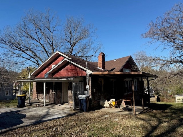 back of property featuring covered porch