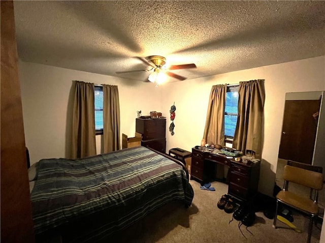 bedroom featuring carpet flooring, a textured ceiling, and ceiling fan