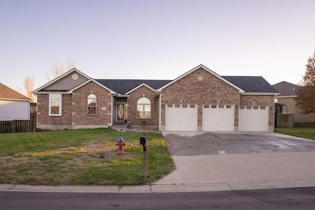 ranch-style home featuring a yard and a garage