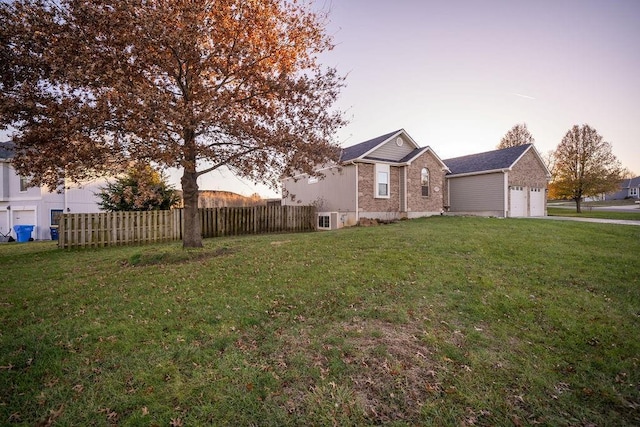 view of front of property featuring a garage and a lawn