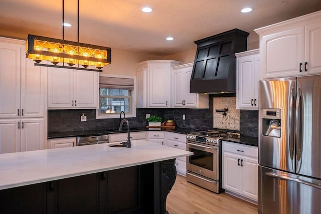 kitchen with dark stone counters, stainless steel appliances, white cabinetry, and pendant lighting