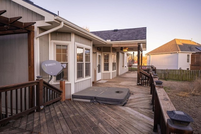 deck at dusk with a covered hot tub