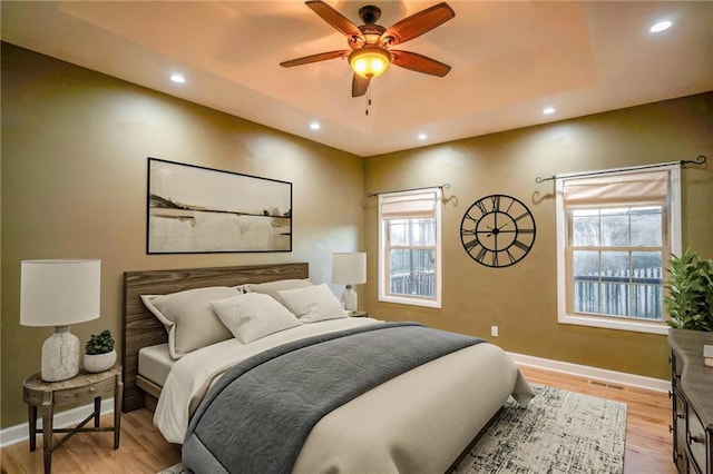 bedroom featuring ceiling fan and light hardwood / wood-style flooring