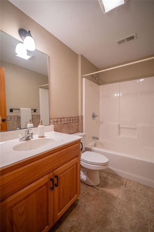 full bathroom with toilet, shower / bathing tub combination, and vanity