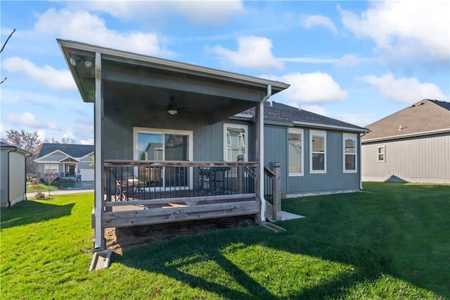 back of house with a lawn and a wooden deck