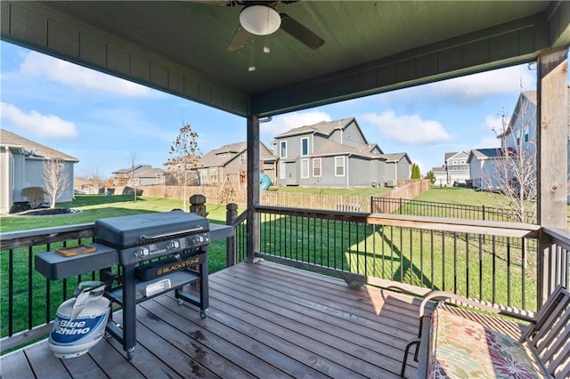 deck with ceiling fan and a yard