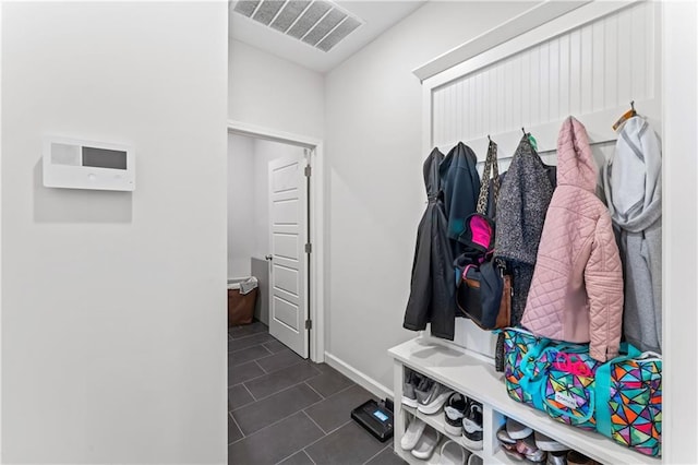 mudroom featuring dark tile patterned floors