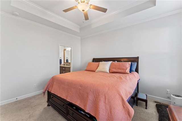 bedroom featuring light carpet, a tray ceiling, ceiling fan, and ornamental molding