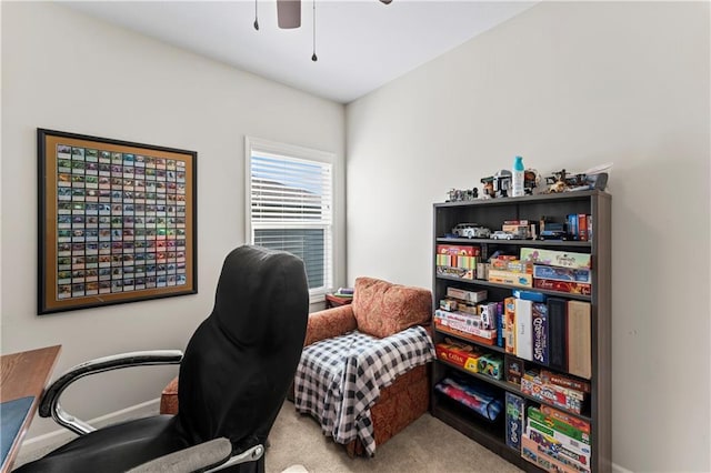 carpeted office space with ceiling fan