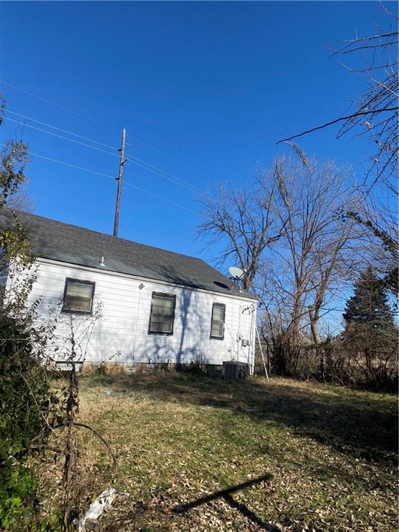 view of side of home featuring a yard