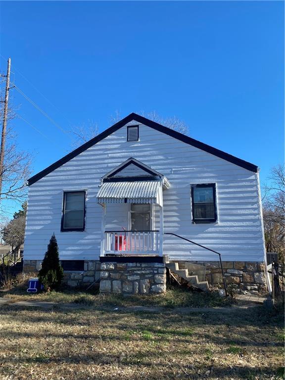 back of property with a lawn