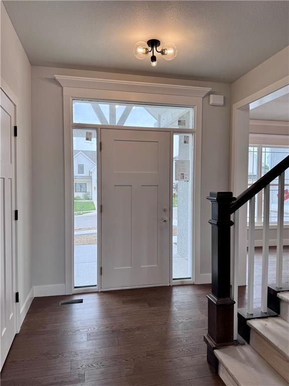 7601 NE 103rd Ter, Kansas City, MO 64157 - foyer entrance with dark wood-type flooring and baseboards