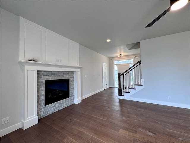 7601 NE 103rd Ter, Kansas City, MO 64157 - unfurnished living room with dark wood finished floors, baseboards, ceiling fan, a fireplace, and recessed lighting