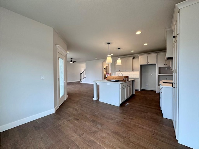 7601 NE 103rd Ter, Kansas City, MO 64157 - kitchen featuring a center island with sink, recessed lighting, baseboards, dark wood finished floors, and open floor plan