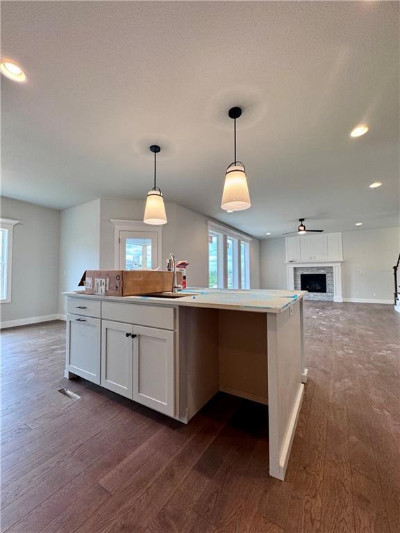 7601 NE 103rd Ter, Kansas City, MO 64157 - kitchen with open floor plan, dark wood finished floors, baseboards, and recessed lighting