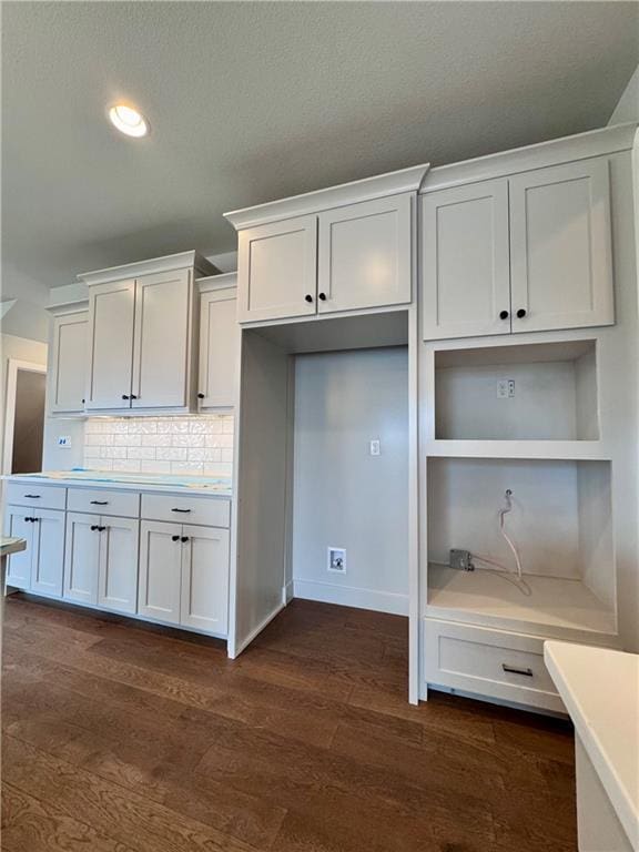 7601 NE 103rd Ter, Kansas City, MO 64157 - kitchen with light countertops, dark wood-type flooring, decorative backsplash, white cabinetry, and recessed lighting