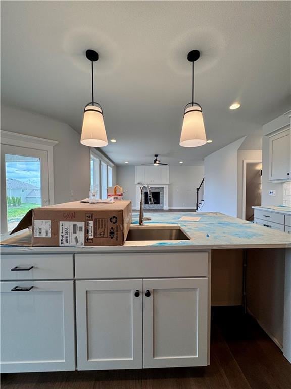 7601 NE 103rd Ter, Kansas City, MO 64157 - kitchen with a sink, dark wood-style flooring, white cabinetry, and recessed lighting