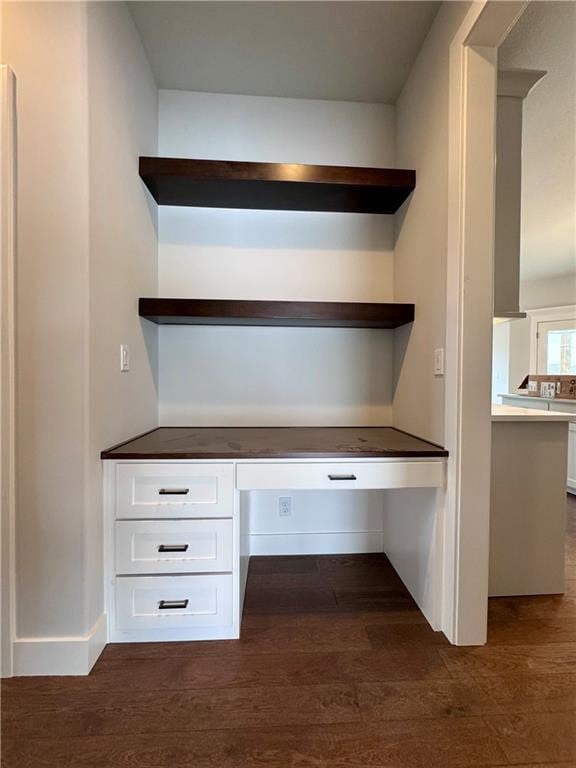 7601 NE 103rd Ter, Kansas City, MO 64157 - unfurnished office with built in desk and dark wood-style floors