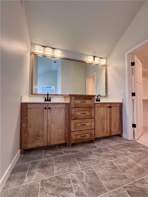 7601 NE 103rd Ter, Kansas City, MO 64157 - full bathroom featuring double vanity, baseboards, and lofted ceiling