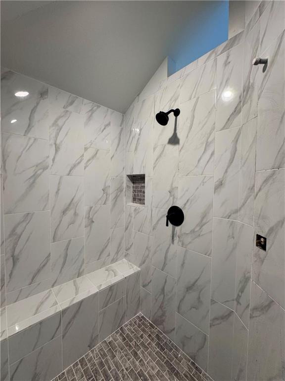7601 NE 103rd Ter, Kansas City, MO 64157 - full bathroom with a tile shower and lofted ceiling