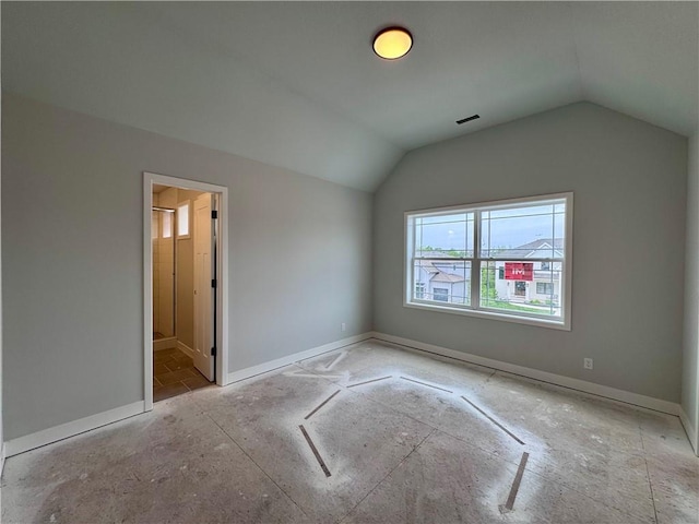 7601 NE 103rd Ter, Kansas City, MO 64157 - unfurnished bedroom featuring vaulted ceiling, baseboards, and connected bathroom
