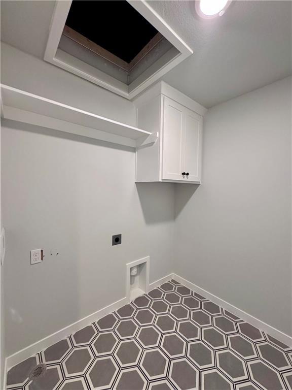 7601 NE 103rd Ter, Kansas City, MO 64157 - laundry area with hookup for an electric dryer, baseboards, and tile patterned floors