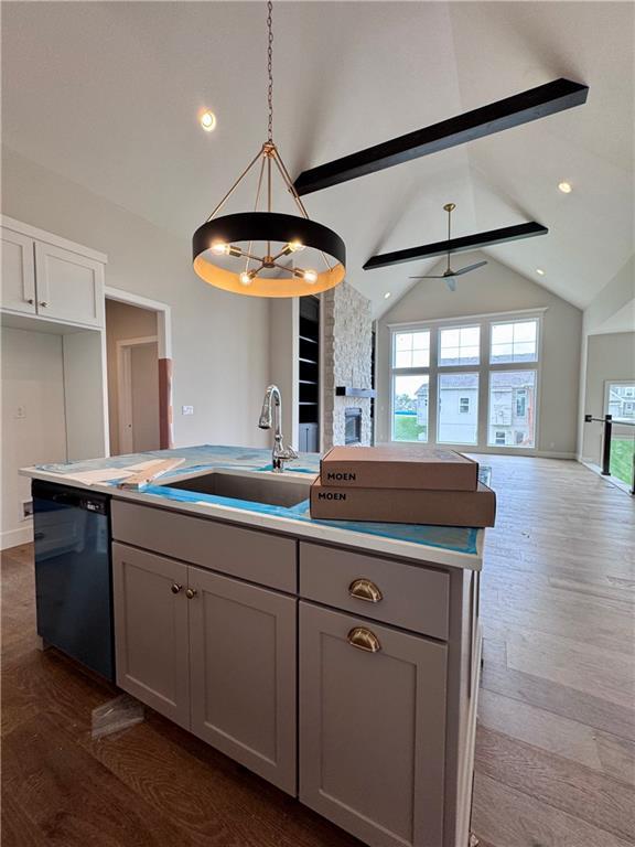 7719 NE 103rd Ter, Kansas City, MO 64157 - kitchen featuring dishwasher, open floor plan, gray cabinets, a sink, and a kitchen island with sink