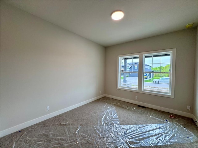 7719 NE 103rd Ter, Kansas City, MO 64157 - carpeted empty room with baseboards and a smoke detector