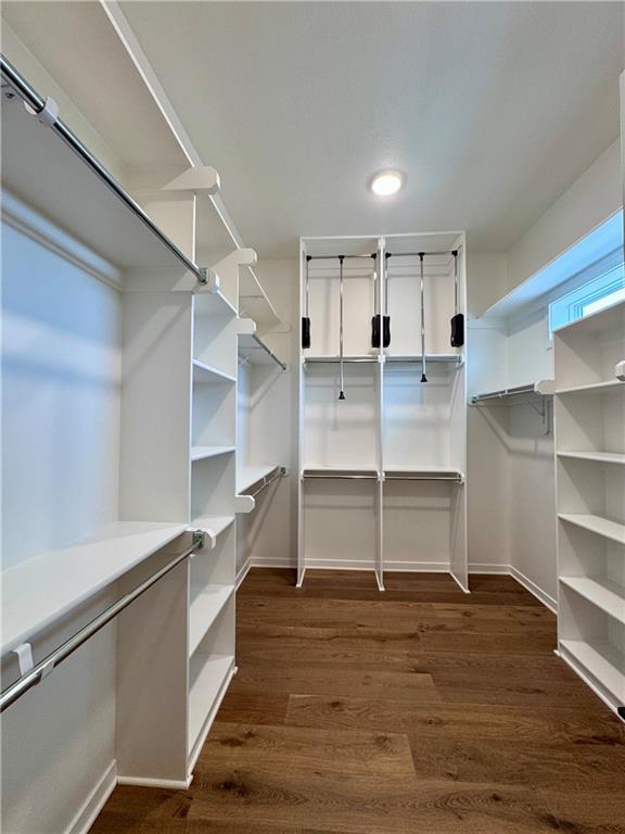 7719 NE 103rd Ter, Kansas City, MO 64157 - spacious closet featuring dark wood-type flooring