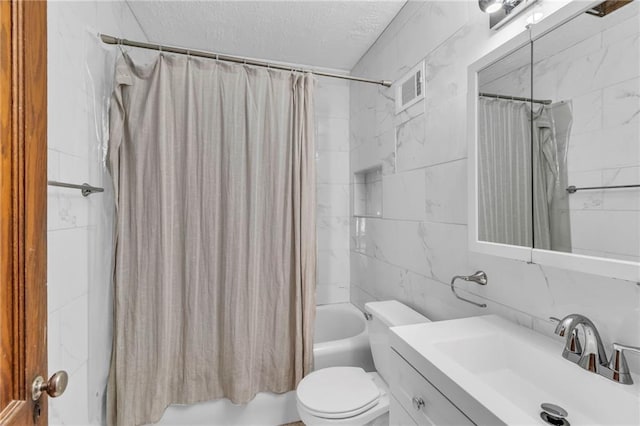 full bathroom with vanity, a textured ceiling, shower / bathtub combination with curtain, tile walls, and toilet