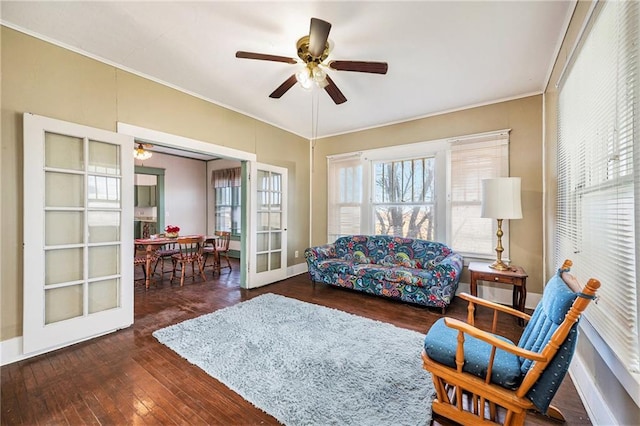 living area featuring ceiling fan, dark hardwood / wood-style flooring, french doors, and ornamental molding