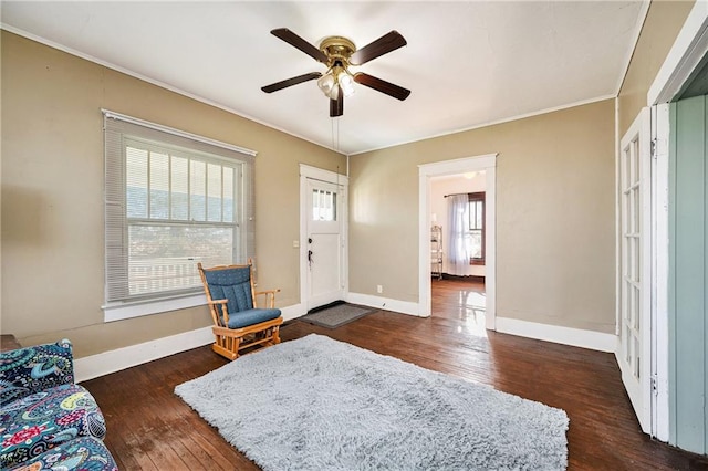 entryway with ceiling fan, dark hardwood / wood-style flooring, and crown molding