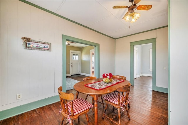 dining space featuring ceiling fan and dark wood-type flooring