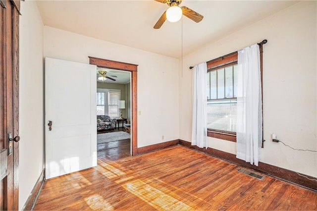 spare room featuring hardwood / wood-style floors and ceiling fan