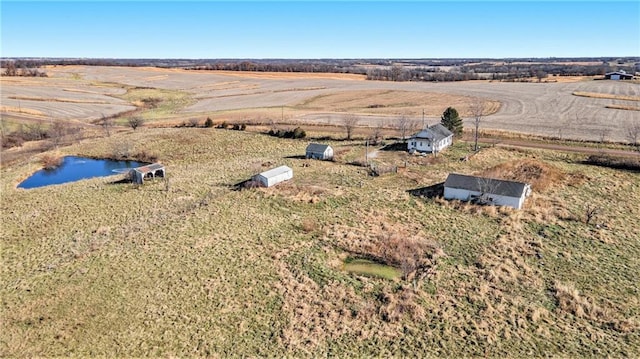 birds eye view of property with a water view and a rural view