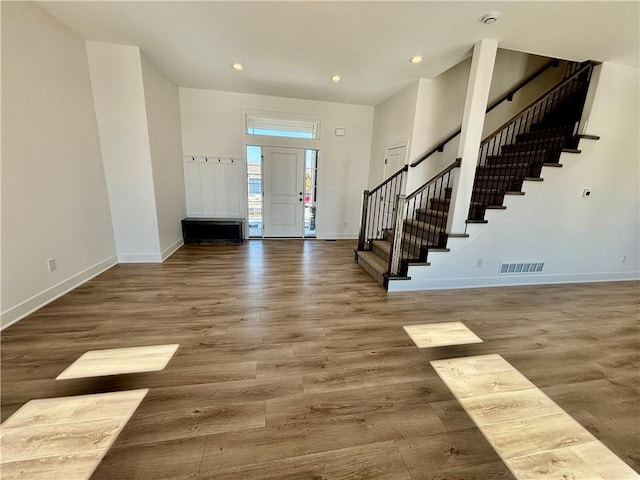 entrance foyer featuring recessed lighting, stairway, baseboards, and wood finished floors